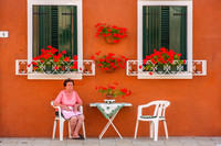 Venice, Burano, Woman at Table, Flowers0943616