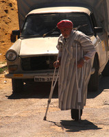 Northern Algeria, Man w Crutches Crossing Street1027304a