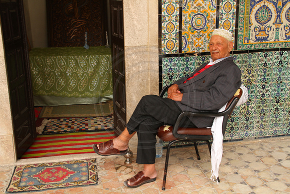 Kairouan, Zaouia Sidi Sahbi Mausoleum, Man in Chairl1026126